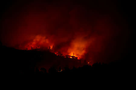 FILE PHOTO: The Camp Fire burns along a ridge near Big Bend, California, U.S. November 10, 2018. REUTERS/Stephen Lam/File Photo