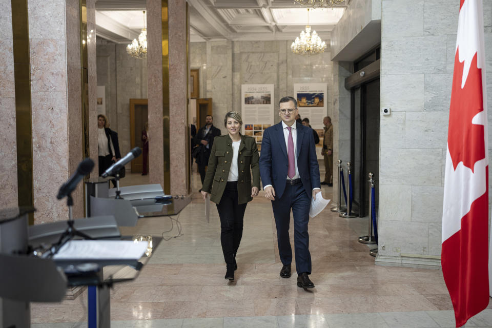 Canada's Foreign Minister Melanie Joly and Ukraine's Foreign Minister Dmytro Kuleba walk in the corridor before press conference in Kyiv, Ukraine, on Friday, Feb. 2, 2024. (AP Photo/Evgeniy Maloletka)