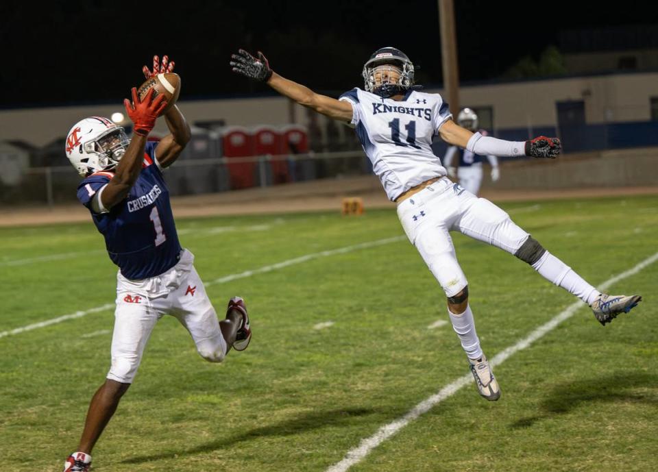 Modesto Christian’s Jeremiah Bernard intercepts a pass intended for Stone Ridge Christian’s Sawyer Wood during the nonleague game at Modesto Christian High School in Salida, Calif., Friday, Sept. 15, 2023.