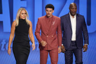 Johnny Davis, center, walks on stage during introductions for the NBA basketball draft, Thursday, June 23, 2022, in New York. (AP Photo/John Minchillo)
