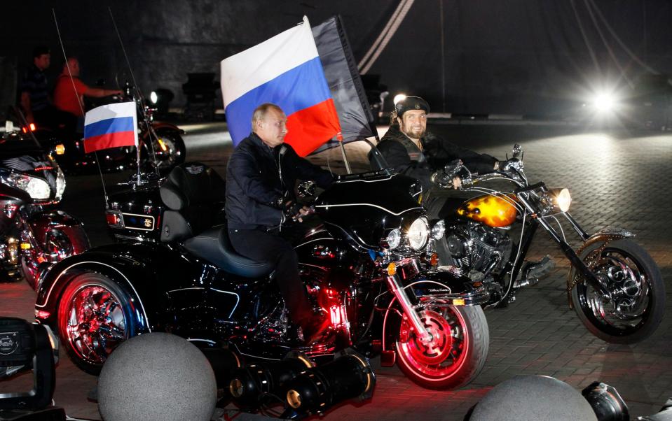 Vladimir Putin rides with Nochniye Volki, leader of the Night Wolves - Ivan Sekretarev/AP