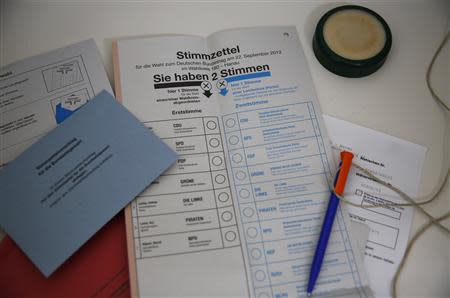 Voting papers for the upcoming German general elections are seen inside a "mail-voting" booth at the town hall of Hanau, 30km south of Frankfurt, August 28, 2013. REUTERS/Kai Pfaffenbach