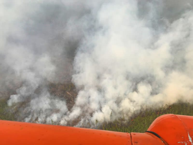 An aerial view shows smoke rising from a forest fire burning in Yakutia