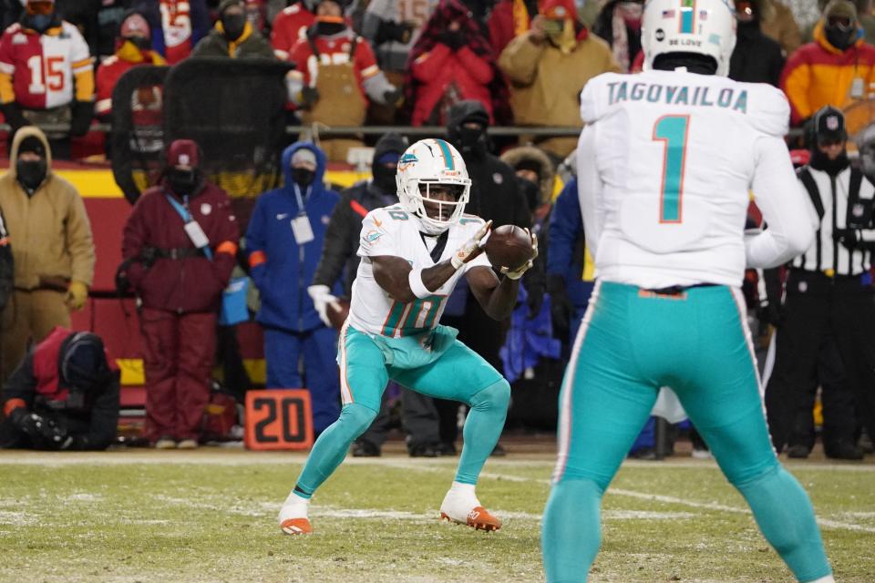 Jan 13, 2024; Kansas City, Missouri, USA; Miami Dolphins wide receiver Tyreek Hill (10) catches a pass from quarterback Tua Tagovailoa (1) during the first half of the 2024 AFC wild card game at GEHA Field at Arrowhead Stadium. Mandatory Credit: Denny Medley-USA TODAY Sports