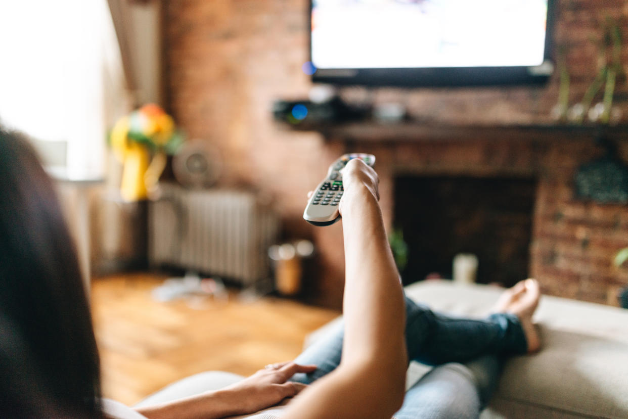 woman looking the tv at home