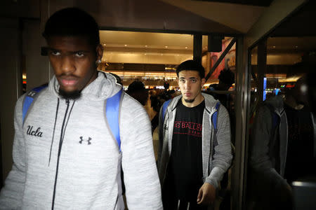 UCLA basketball players LiAngelo Ball (R) and Cody Riley arrive at LAX after flying back from China where they were detained on suspicion of shoplifting, in Los Angeles, California U.S. November 14, 2017. REUTERS/Lucy Nicholson