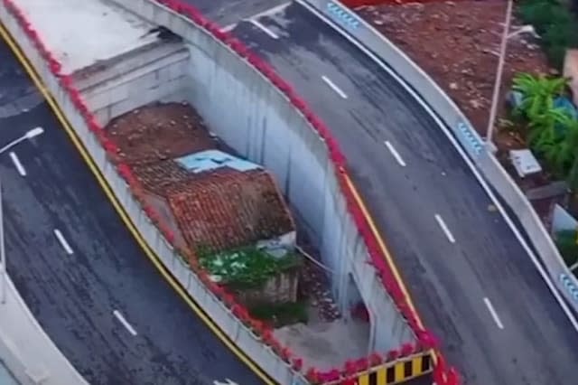 Chinese city builds bridge around woman's house after she refused to move