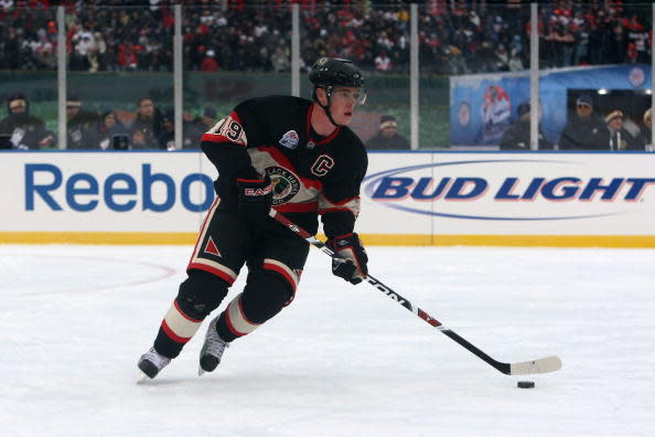 CHICAGO - JANUARY 01: Jonathan Toews #19 of the Chicago Blackhawks skates with the puck against the Detroit Red Wings during the NHL Winter Classic at Wrigley Field on January 1, 2009 in Chicago, Illinois. (Photo by Jonathan Daniel/Getty Images)