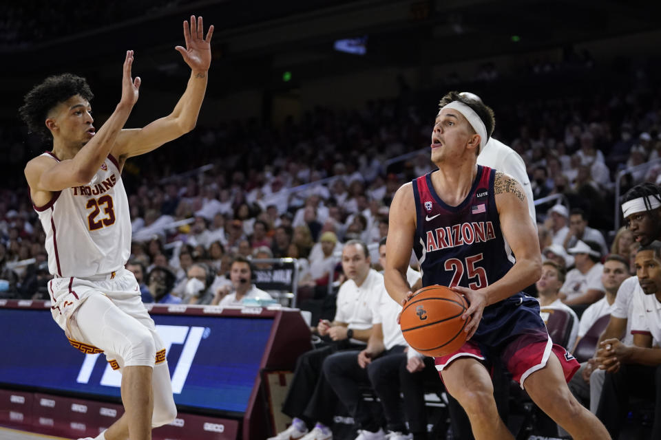 Arizona guard Kerr Kriisa (25) prepares to shoot over Southern California forward Max Agbonkpolo (23) during the first half of an NCAA college basketball game Tuesday, March 1, 2022, in Los Angeles. (AP Photo/Marcio Jose Sanchez)