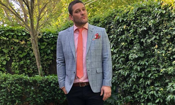 A photo of ex-AFL player Brendan Fevola wearing a suit.