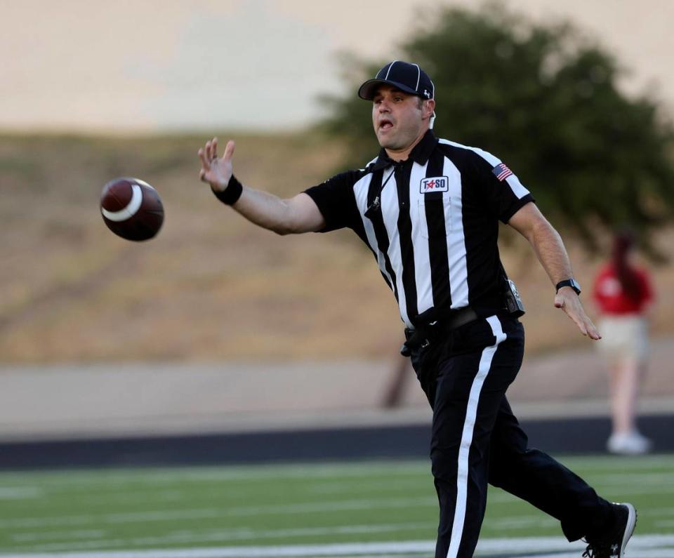 The back judge tosses the ball to the sidelines in the first half of an UIL football game at Keller ISD Stadium in Keller, Texas, Thursday Aug. 31, 2023.