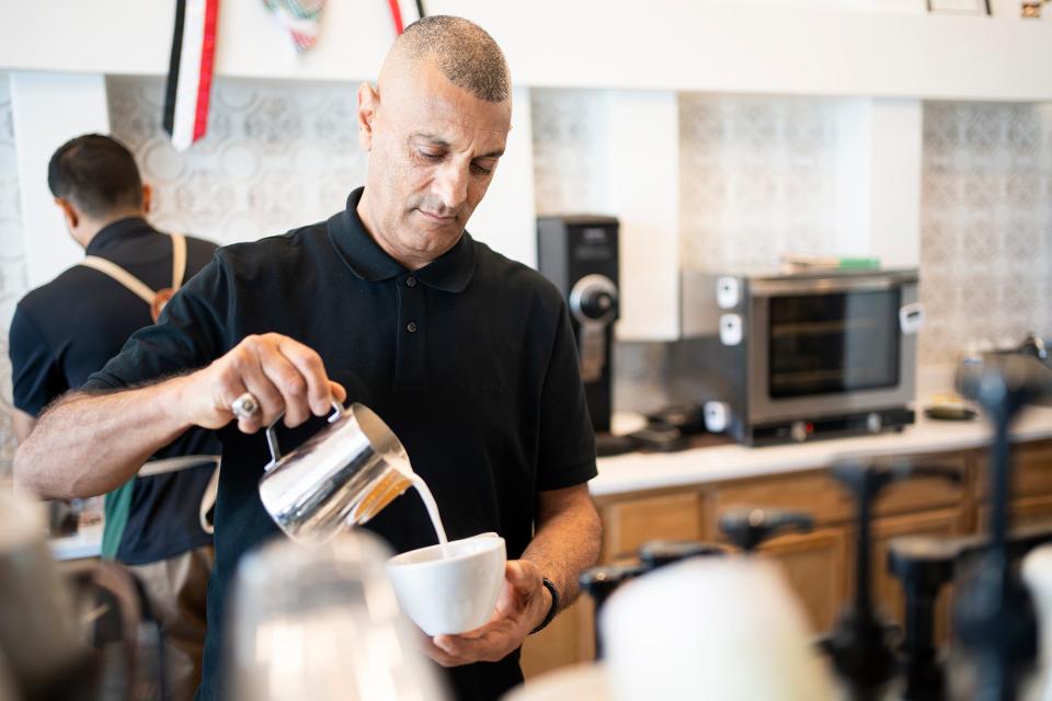 Abdul Nagi, co-owner of Qamaria Yemeni Coffee Co. in Hilliard, makes a latte.