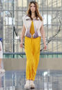 <b>London College of Fashion MA13 runway</b><br><br>Unusual bow-style blouses over yellow with wedged flats.<br><br>©Rex