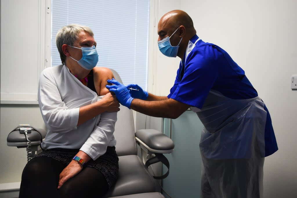 Lead research nurse Vash Deelchand gives a demonstration of the vaccine trial process (PA Archive)