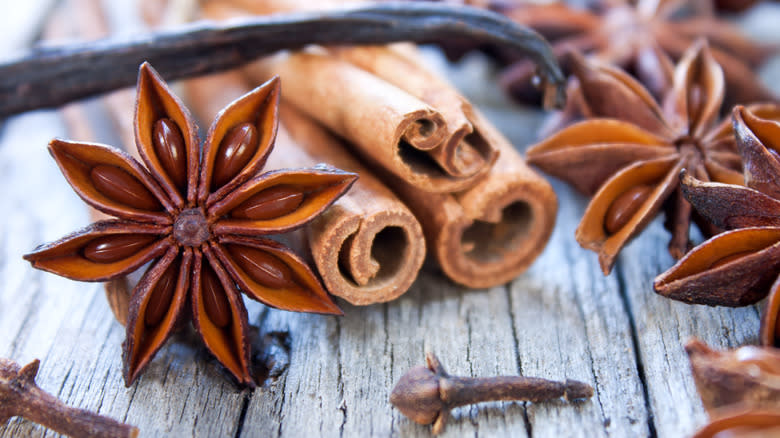 spice sticks laying on wooden surface