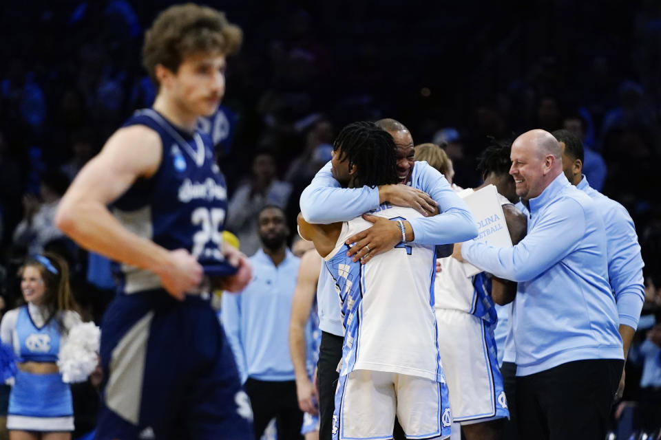 North Carolina's Hubert Davis and Caleb Love celebrate after a college basketball game against St. Peter's in the Elite 8 round of the NCAA tournament, Sunday, March 27, 2022, in Philadelphia. (AP Photo/Chris Szagola)