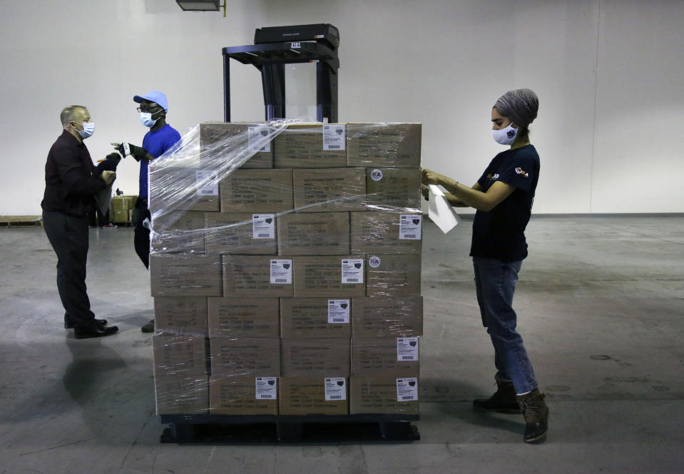 Dr. Abhu Kaur of Khalsa Aid USA, a global humanitarian organization, labels a pallet of electrical transformers, which will be shipped to New Delhi with oxygen concentrators this week, on New York’s Long Island, Friday, May 7, 2021. With teams deployed in India to help support COVID-19 patients, Khalsa Aid USA plans to provide a total of 500 oxygen concentrators and 500 transformers to cities throughout the country. (AP Photo/Jessie Wardarski)