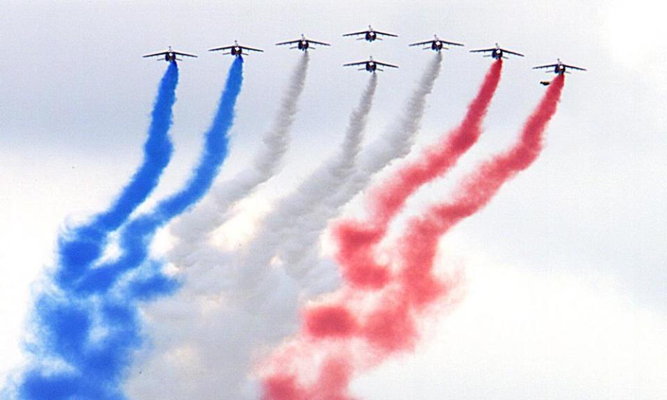 The French air force aerobatic display team, La Patrouille de France, perform a flyby in Alpha jets over Paris on Bastille Day. 