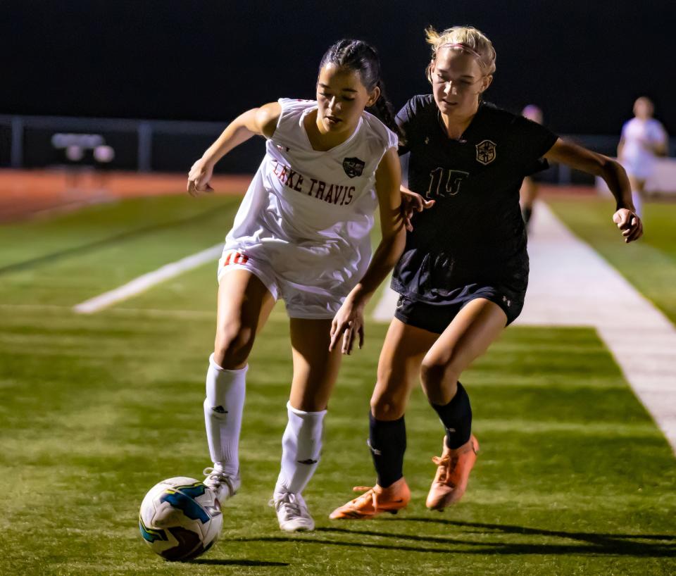 Lake Travis Cavaliers Amelia Clark (10) and Johnson Jaguars Peyton Taylor (15) battle for the ball during the first half at the District 26-6A girls soccer game on Friday, Feb 9, 2024 at Johnson High School in Buda, TX.