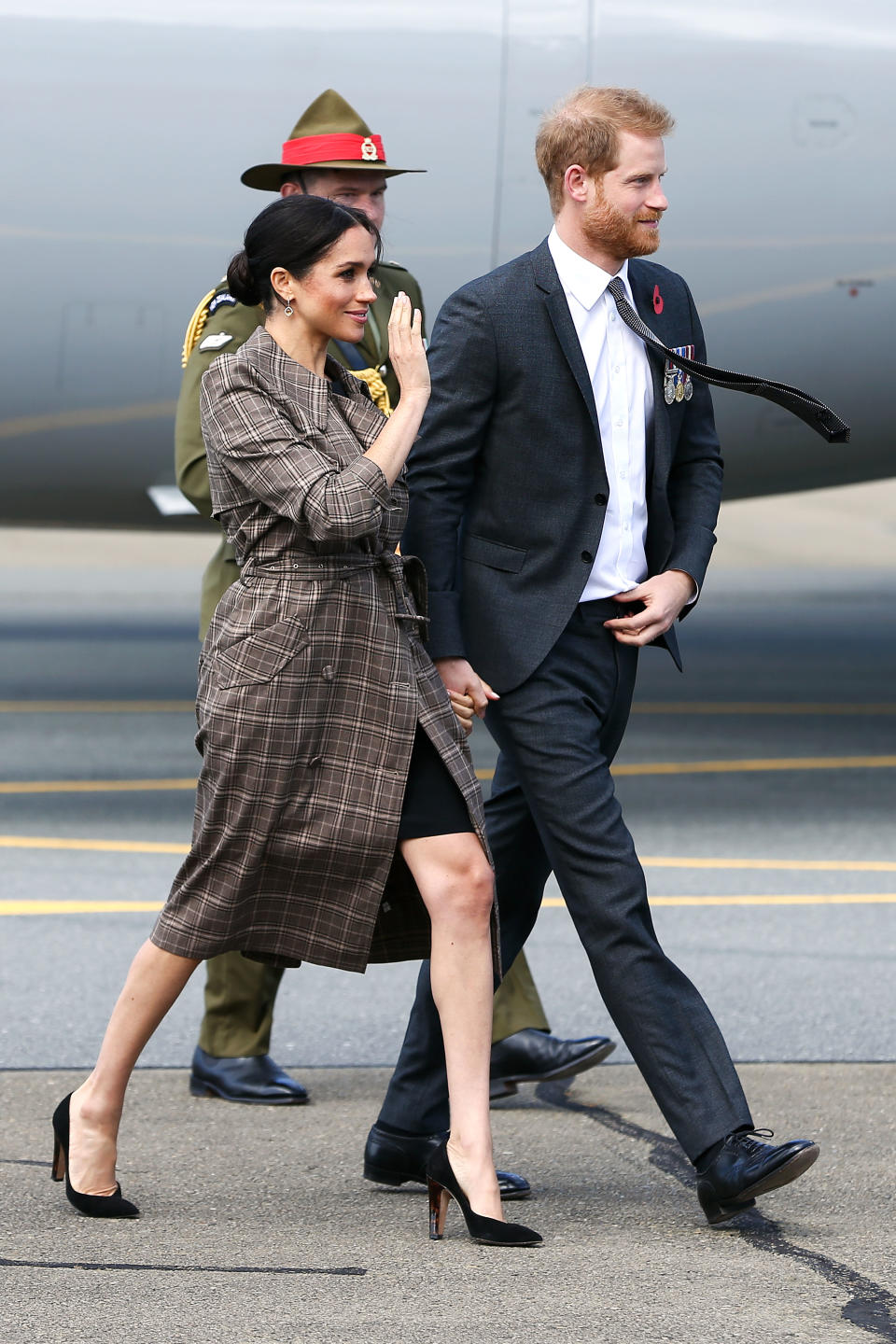 <p>After a quick outfit change, the Duchess touched down in New Zealand wearing a £35 ASOS maternity dress with a Karen Walker plaid trench to finish the ensemble. <em>[Photo: Getty]</em> </p>