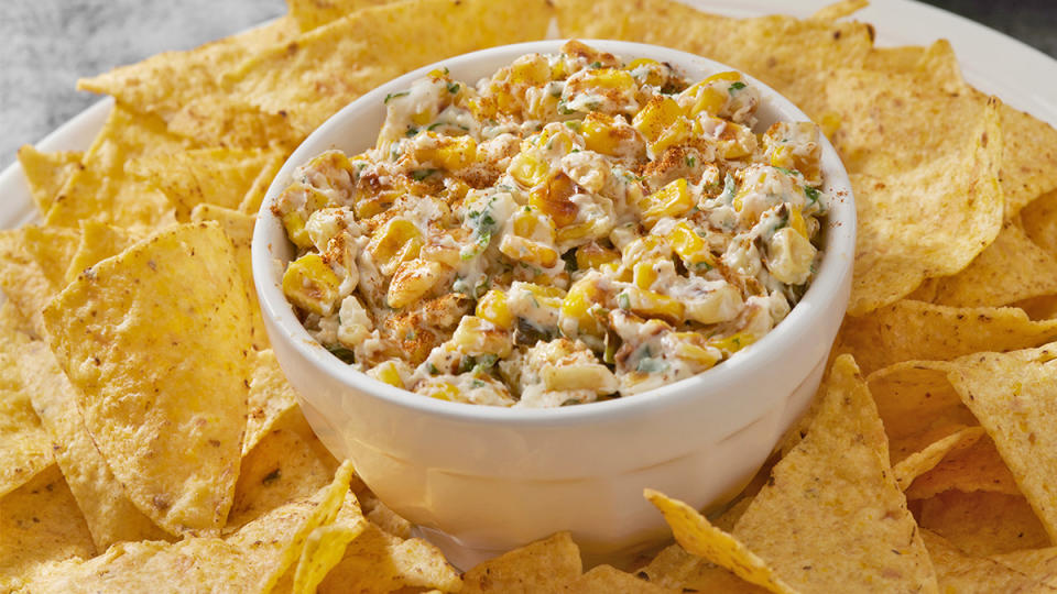 A bowl of elote dip (snack spread made with the flavors and ingredients found in Mexican street corn)