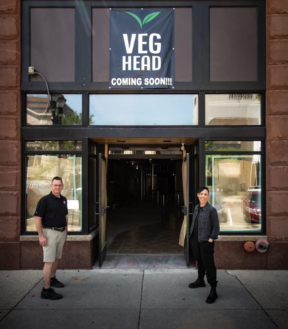 Chef Kari Magee, right, pictured with restaurateur Shawn Elliott, Tuesday, May 24, 2022, in front of their forthcoming restaurant Veg Head on Washington Square in downtown Lansing. Magee plans to open this fall. "I want people to reimagine the vegan dining experience - change some of the misconceptions around vegan dishes. Say you're out with a strict vegan but you'd rather have a more traditional comfort food-option. Vegan food doesn't have to be bland. You can still enjoy a vegan burger or vegan taco from our scratch kitchen without sacrificing flavor."