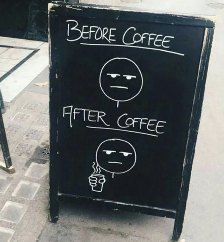 Sidewalk chalkboard with two drawings of emotionless faces labeled "Before Coffee" and "After Coffee." The second face holds a steaming cup