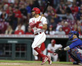 Cincinnati Reds' Tommy Pham, left, watches his home run in front of Chicago Cubs catcher Yan Gomes during the sixth inning of a baseball game in Cincinnati, Monday, May 23, 2022. (AP Photo/Paul Vernon)