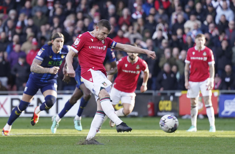 Wrexham's Paul Mullin scores their side's second goal from the penalty spot during the English League Two soccer match between Wrexham and Mansfield Town at the SToK Cae Ras in Wrexham, Wales, Friday, March 29, 2024. (Jacob King/PA via AP)