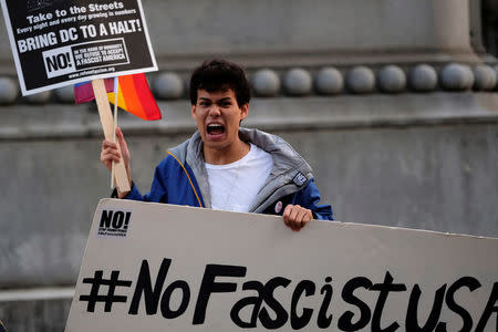 An anti-Trump demonstrator participates in a protest organized by RefuseFascism.org at McPherson Square in Washington January 18, 2017. REUTERS/James Lawler Duggan
