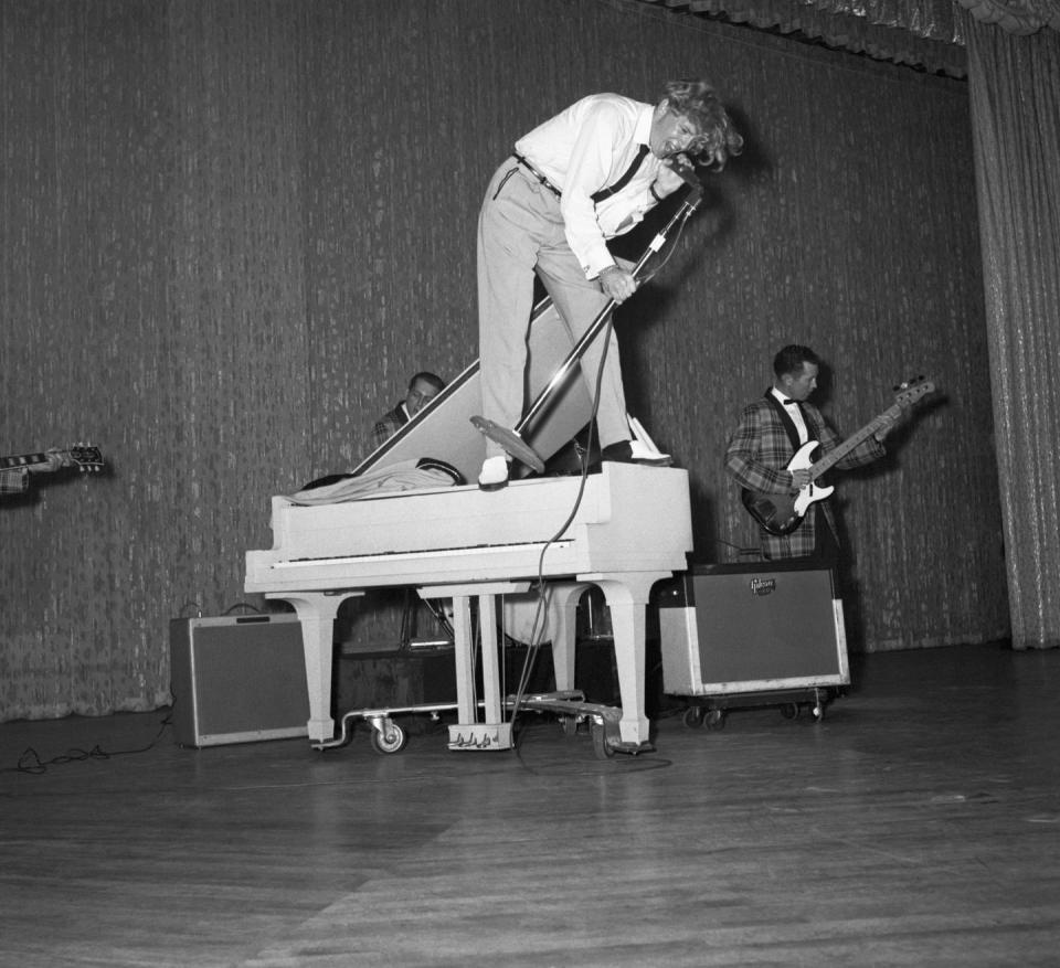 jerry lee lewis singing atop a piano