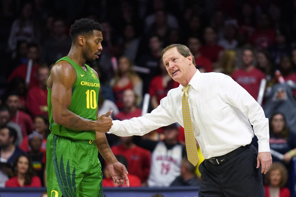 Oregon coach Dana Altman jokes with Shakur Juiston (10) during the first half of the team's NCAA college basketball game against Arizona on Saturday, Feb. 22, 2020, in Tucson, Ariz. (AP Photo/Rick Scuteri)