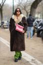 <p>Clashing colours is one way to make your outfit stand-out, demonstrated here with the pairing of the pink Chanel bag and bright green trousers. </p>