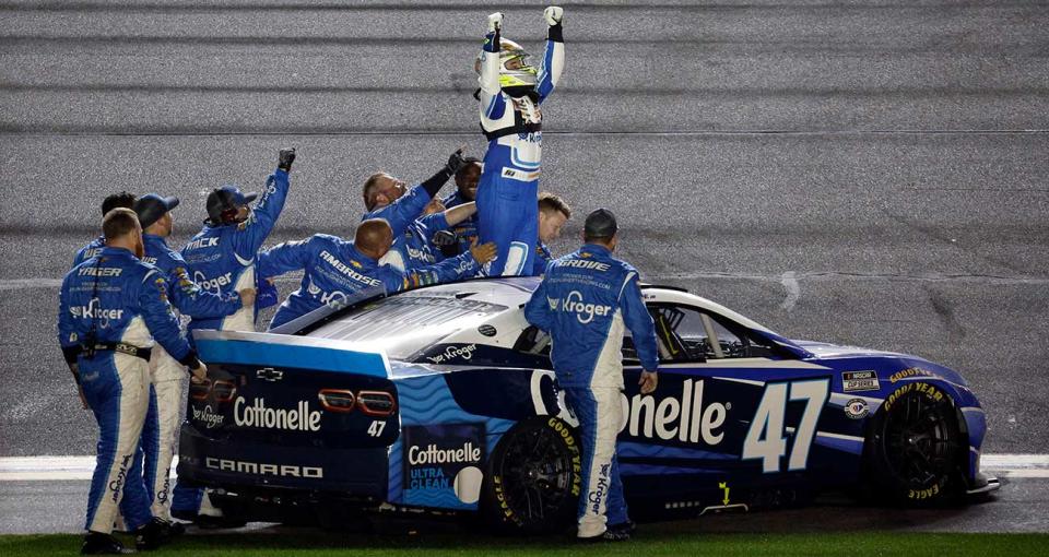 Ricky Stenhouse Jr. raises his arms in celebration with the No. 47 team after their Daytona 500 victory