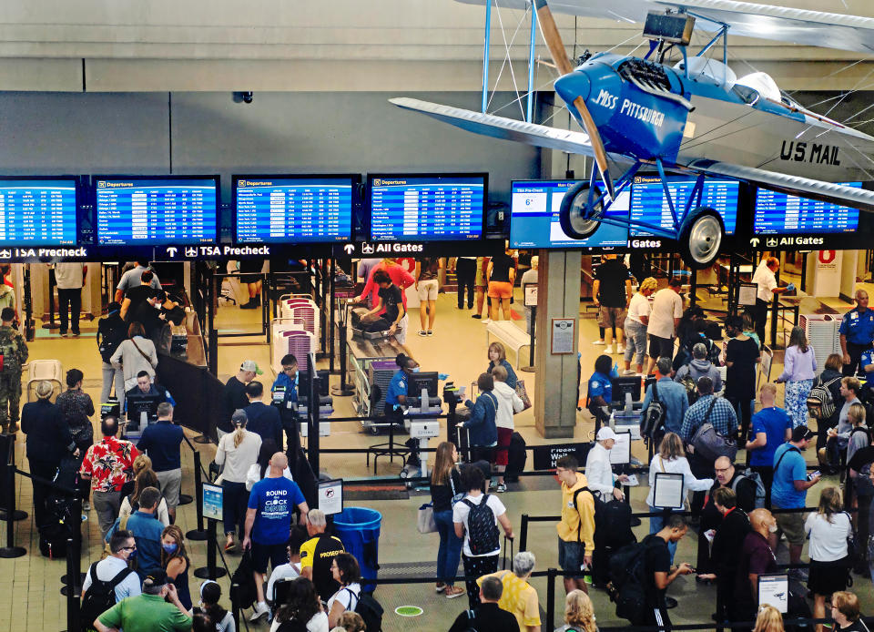 Passengers make their way through a security line Thursday, June 30, 2022, at the Pittsburgh International Airport in Moon Township, Pa. The airport saw an influx of travelers departing Pittsburgh before the Fourth of July holiday weekend. (Morgan Timms/Pittsburgh Post-Gazette via AP)