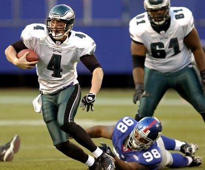 Mike McMahon tries to elude a Giants tackler after taking over for Donovan McNabb in the 2005 season.