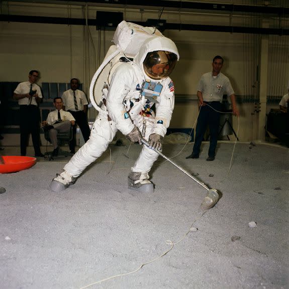 Neil  Armstrong practices scooping up moon rocks a few months before launching.