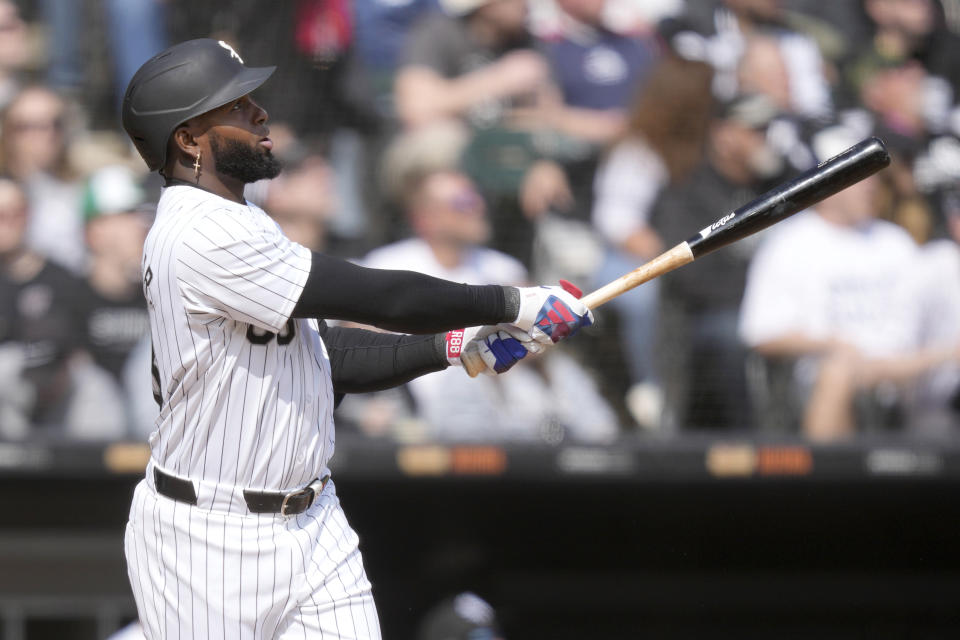 Chicago White Sox's Luis Robert Jr. watches his two-run home run off Detroit Tigers starting pitcher Kenta Maeda, Robert Jr.'s second of the game off Maeda, during the third inning of a baseball game Saturday, March 30, 2024, in Chicago. Yoan Moncada also scored on the play. (AP Photo/Charles Rex Arbogast)