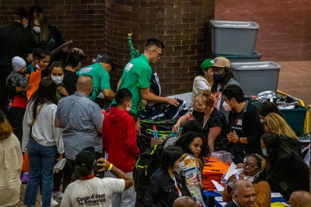 Asylum seekers fill out paper work and receive shoes and other items inside the Port Authority bus terminal in New York on Sept. 9, 2022. 