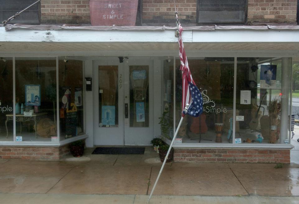 A torn U.S. Flag dangles from a store front in Morgan City, Louisiana ahead of Tropical Storm Barry Saturday, July 13,2019. - Tropical Storm Barry is the first tropical storm system of 2019 to make landfall in the United States and could dump up to two feet of rain along with strong winds and storm-surge flooding according to weather reports. (Photo by Seth HERALD / AFP)        (Photo credit should read SETH HERALD/AFP/Getty Images)