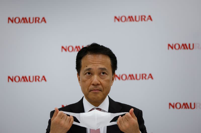 FILE PHOTO: Nomura Holdings Inc. Chief Executive Kentaro Okuda attends a news conference in Tokyo