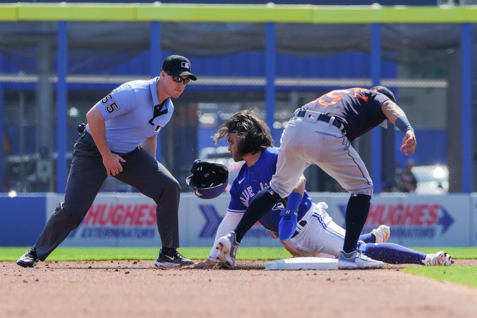 Toronto Blue Jays shortstop Bo Bichette (11) is tagged out at second base during the first inning against the Detroit Tigers at TD Ballpark in Dunedin, Florida, on Tuesday, Feb. 28, 2023.