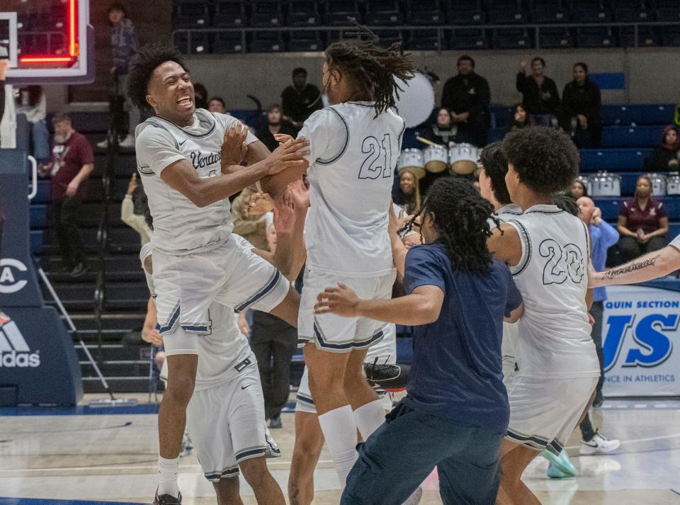 Venture Academy' Toriano Woods, Jr., left, and and Ray Wiggins celebrate their win over Natomas in the Sac-Joaquin Section Div. 4 boys basketball championship game at U.C. Davis' University Credit Union Center in Davis on Feb. 23, 2024. Venture Academy won 78-74.