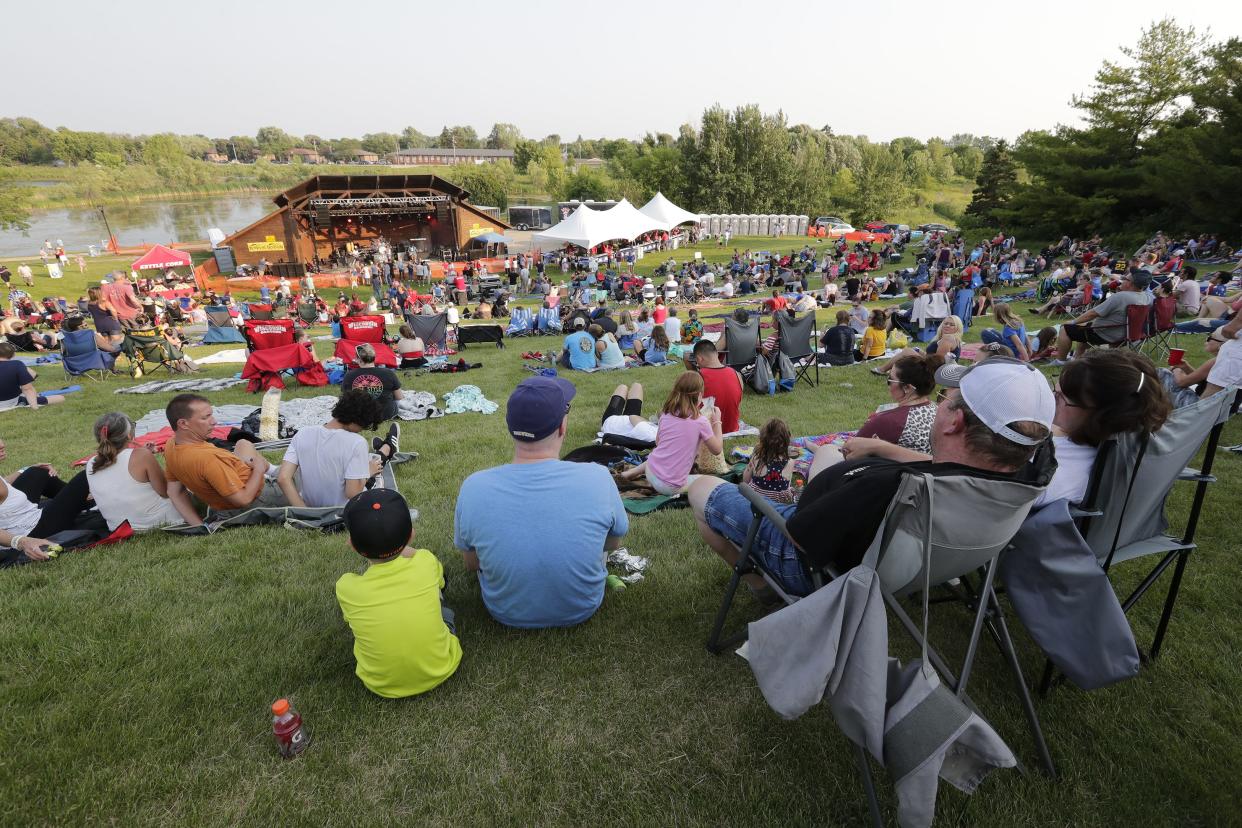 Attendees listen to music during the July 3, 2021, festivities at Memorial Park in Appleton.