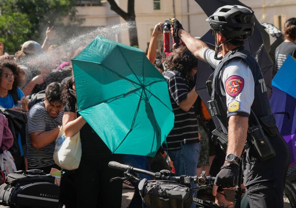 A Texas Department of Public Safety trooper pepper sprays protesters during Monday's pro-Palestinian protest at the University of Texas.