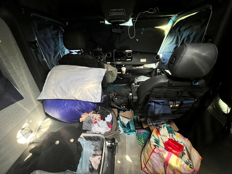 bags and suitcases thrown into the back of a sprinter van