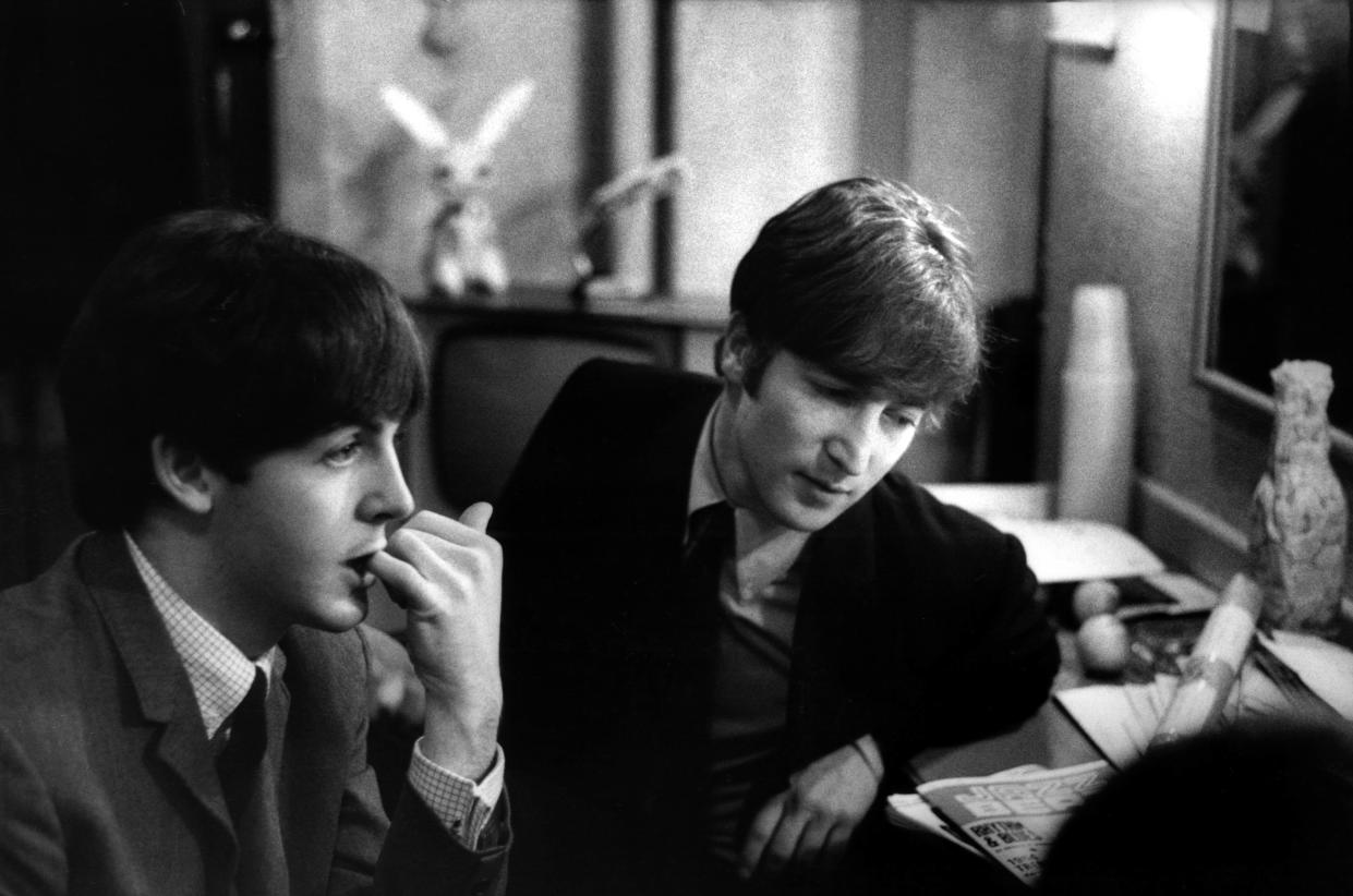 Paul McCartney and John Lennon (1940-1980) from The Beatles posed backstage at the Finsbury Park Astoria, London during the band's Christmas Show residency on 30th December 1963.  (Photo by Val Wilmer/Redferns)