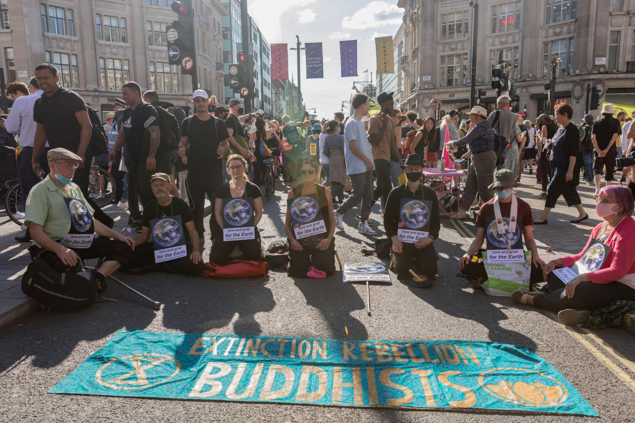 LONDON, UNITED KINGDOM - 2021/08/25: Protesters seen sitting on the Streets while holding placards during the demonstration.
On the 3rd day of Extinction Rebellion's protests, protesters came together with the aim of demanding climate justice for the Indigenous people of Amazon rainforests in Brazil. They protest against ecocide and deforestation in Brazil. The group began their demonstration outside Brazilian Embassy in London, then moved over to Piccadilly Circus, and lastly occupying Oxford Circus. (Photo by Belinda Jiao/SOPA Images/LightRocket via Getty Images)