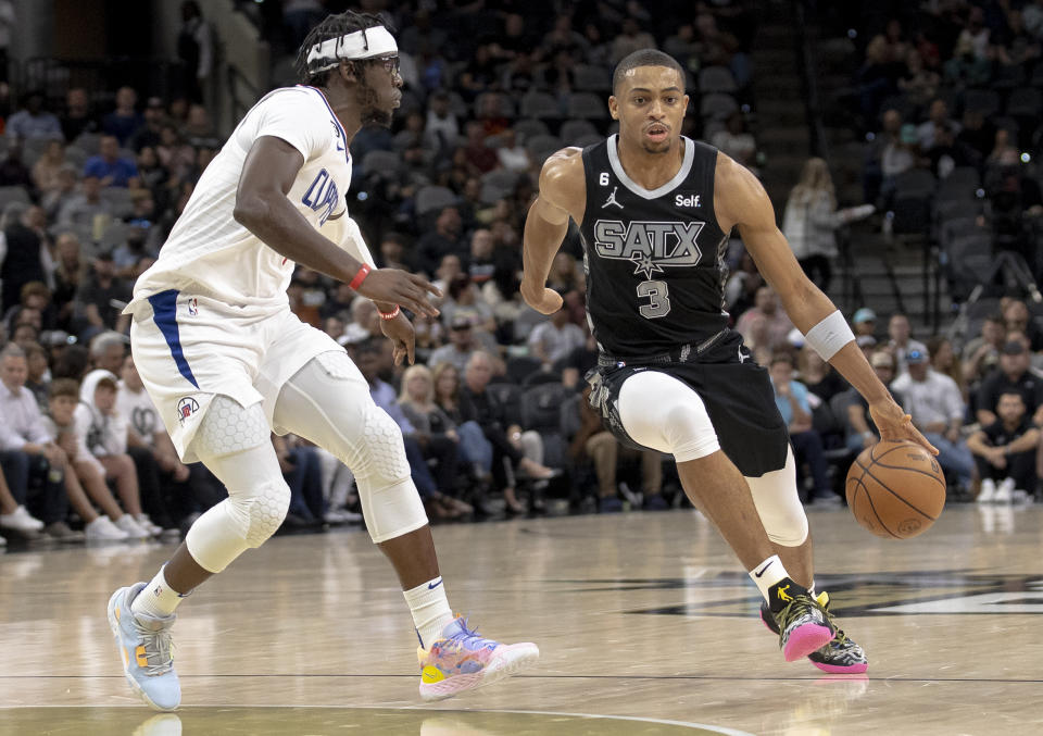 San Antonio Spurs forward Keldon Johnson (3) drives against Los Angeles Clippers guard Reggie Jackson during the first half of an NBA basketball game Friday, Nov. 4, 2022, in San Antonio. (AP Photo/Nick Wagner)