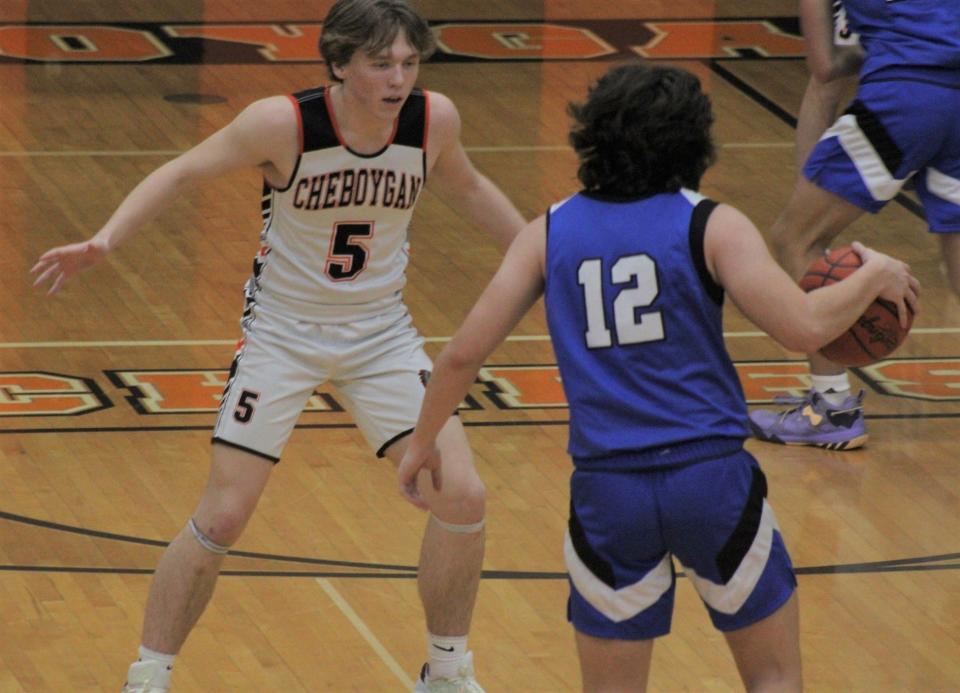 Cheboygan's Caden Gardner (5) defends Inland Lakes' Payton Teuthorn (12) during a boys basketball game last season. The Cheboygan and I-L boys will also be playing at Little Caesars Arena on Tuesday, Dec. 26.